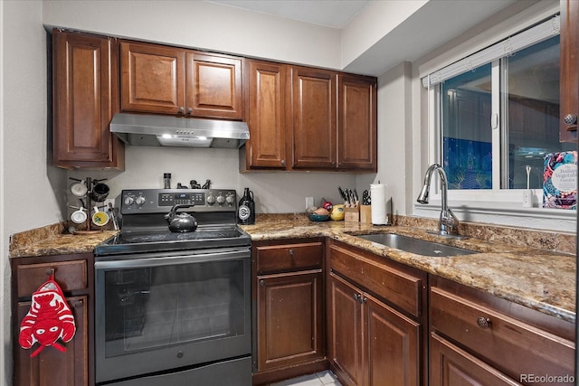 kitchen with black range with electric cooktop, a sink, light stone countertops, and under cabinet range hood