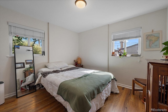 bedroom with wood finished floors and baseboards