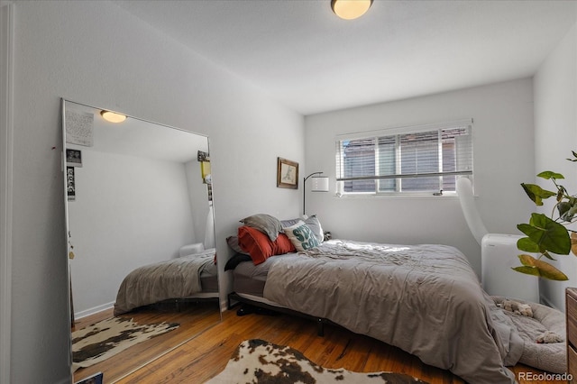 bedroom featuring wood finished floors