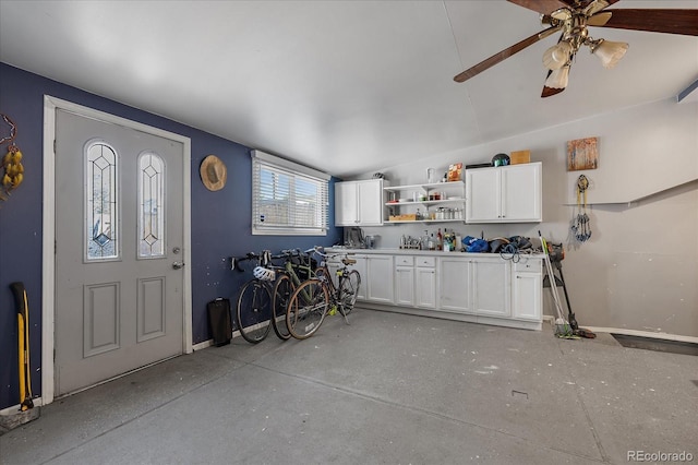 garage featuring ceiling fan and baseboards