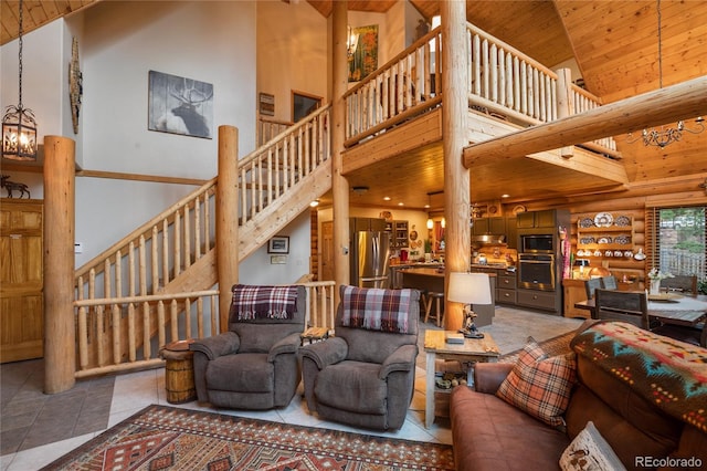 2255 Spruce Rd, Woodland Park, CO 80863 - tiled living area with a towering ceiling, wooden ceiling, log walls, and stairway