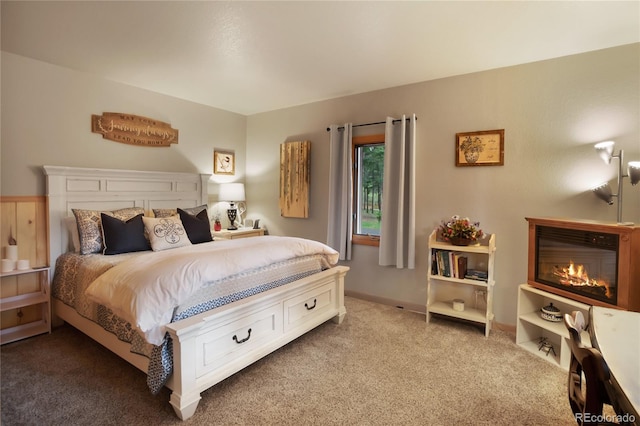 2255 Spruce Rd, Woodland Park, CO 80863 - carpeted bedroom featuring a glass covered fireplace