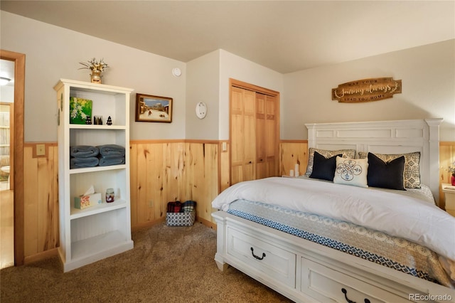 2255 Spruce Rd, Woodland Park, CO 80863 - bedroom featuring a wainscoted wall, carpet flooring, wooden walls, and a closet