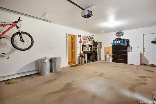2255 Spruce Rd, Woodland Park, CO 80863 - garage featuring a garage door opener, refrigerator, and a baseboard radiator