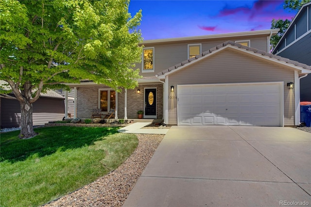 10016 Teton Ct, Lone Tree, CO 80124 - view of front of home with concrete driveway, a yard, and a garage