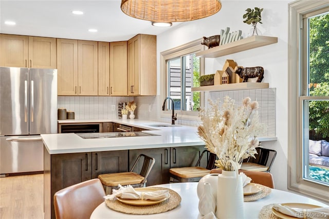 10016 Teton Ct, Lone Tree, CO 80124 - kitchen with freestanding refrigerator, open shelves, decorative backsplash, light countertops, and a peninsula