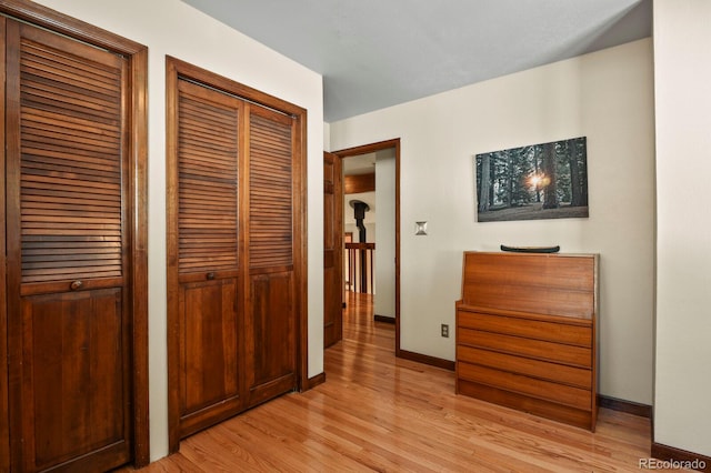 hallway with light hardwood / wood-style flooring