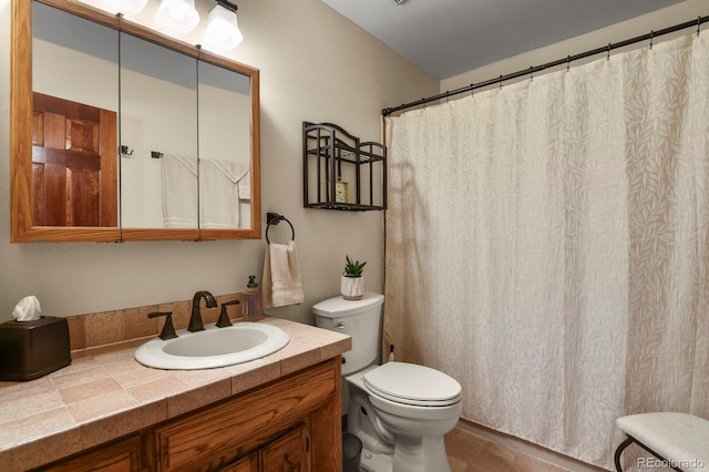 bathroom featuring tile patterned floors, vanity, and toilet