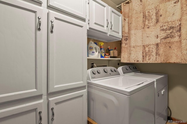 laundry room featuring cabinets and separate washer and dryer