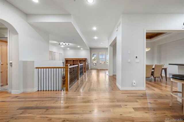 4364 Chateau Ridge Ln, Castle Rock, CO 80108 - hall featuring arched walkways, wood finished floors, and recessed lighting