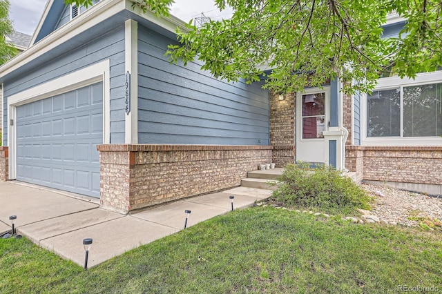 exterior space featuring a garage and brick siding