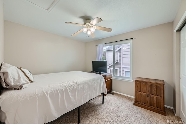 bedroom with light carpet, ceiling fan, and baseboards