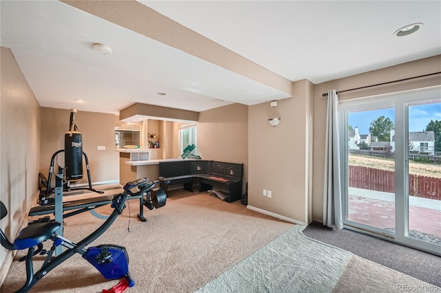 exercise room featuring carpet floors and baseboards