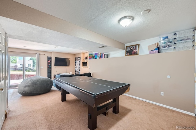 game room featuring baseboards, visible vents, a textured ceiling, and light colored carpet