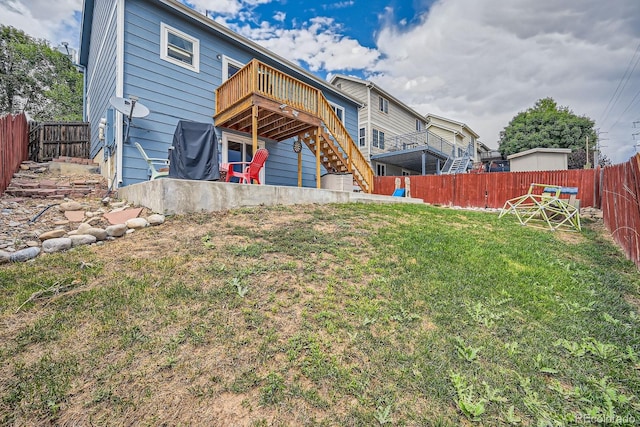 rear view of property with a yard, a fenced backyard, stairs, and a wooden deck