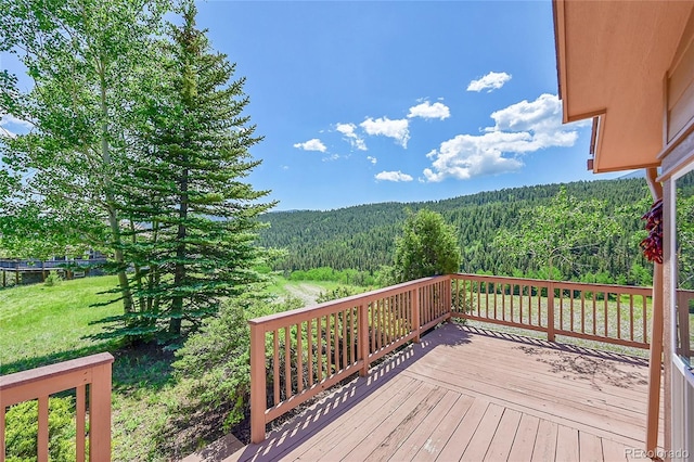 153 Gold Run Trl, Idaho Springs, CO 80452 - deck with a wooded view and a yard