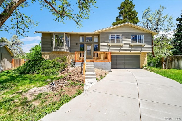 7448 W Geddes Pl, Littleton, CO 80128 - view of front of house featuring brick siding, a garage, and concrete driveway