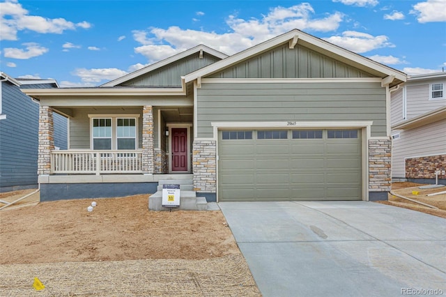 20590 E 58th Ave, Aurora, CO 80019 - craftsman house with covered porch, board and batten siding, stone siding, and driveway
