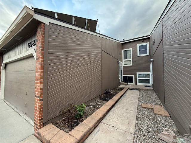 6921 S Bryant St, Littleton, CO 80120 - view of home's exterior with brick siding and a garage