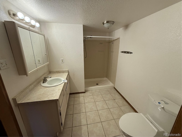 6921 S Bryant St, Littleton, CO 80120 - bathroom featuring a textured ceiling, a stall shower, vanity, toilet, and tile patterned floors