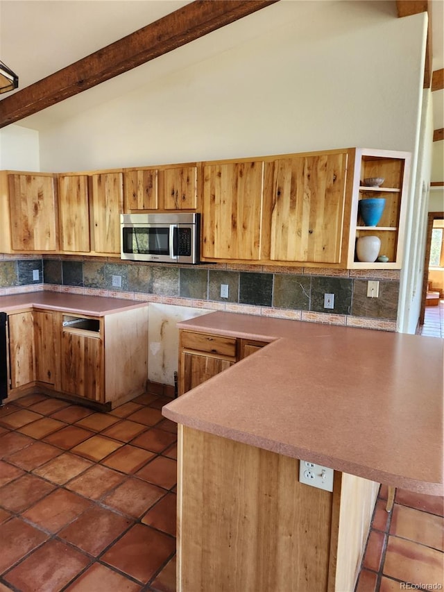 kitchen featuring high vaulted ceiling, beamed ceiling, dark tile patterned floors, and decorative backsplash