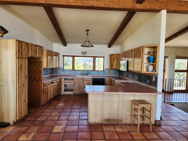 kitchen with dark tile patterned floors, decorative backsplash, sink, pendant lighting, and kitchen peninsula