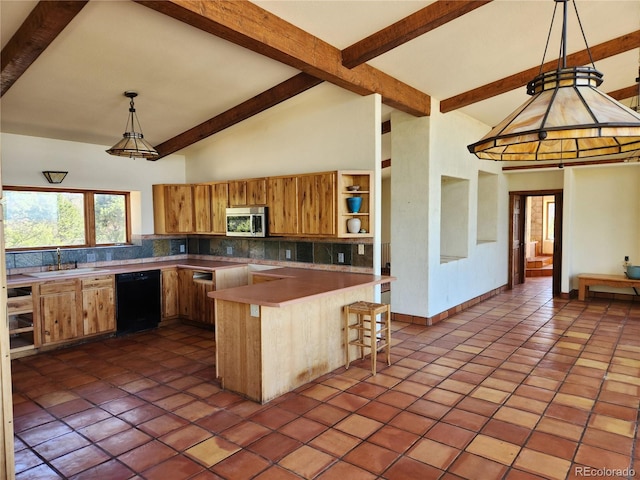 kitchen with appliances with stainless steel finishes, sink, tile patterned floors, a breakfast bar area, and hanging light fixtures