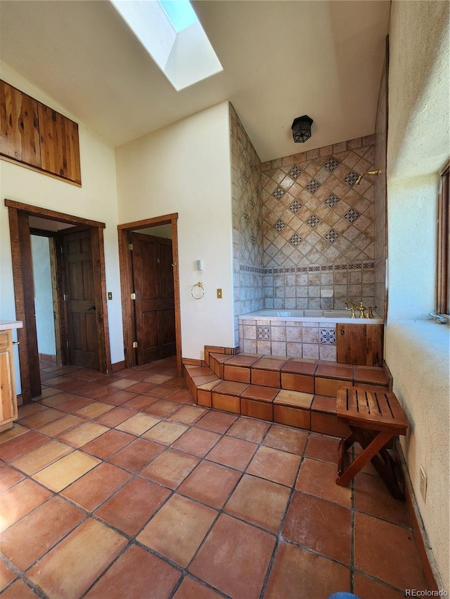 bathroom with tile patterned flooring and a skylight