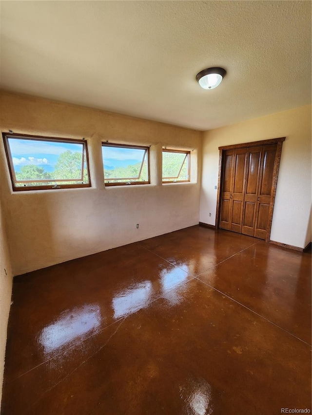 unfurnished bedroom with a textured ceiling