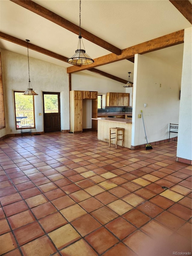 unfurnished living room featuring high vaulted ceiling, light tile patterned floors, and beamed ceiling