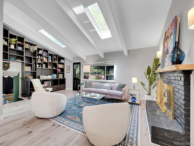 living room featuring lofted ceiling with beams, plenty of natural light, and hardwood / wood-style floors