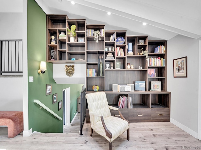 sitting room featuring lofted ceiling and light hardwood / wood-style flooring