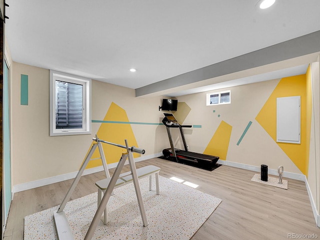 workout room with light hardwood / wood-style floors