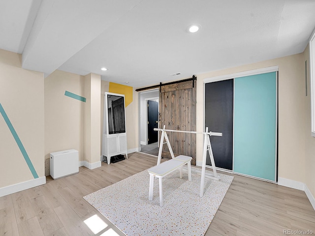 interior space featuring light hardwood / wood-style flooring and a barn door