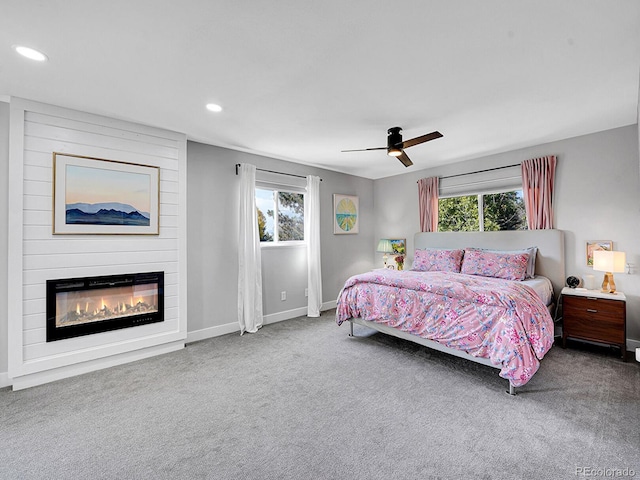 bedroom with carpet flooring, multiple windows, and ceiling fan