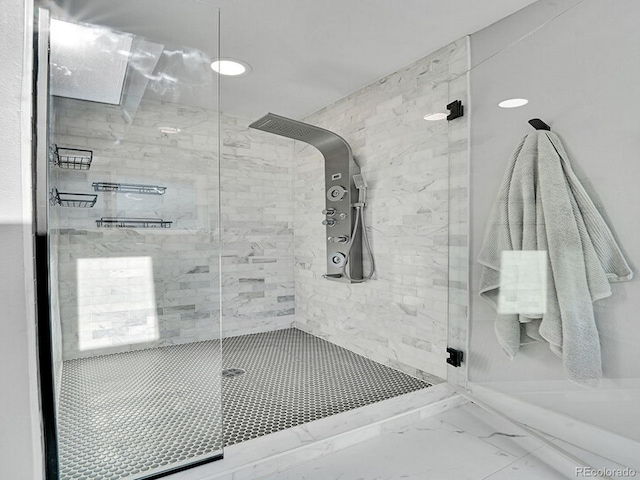 bathroom featuring a shower with shower door