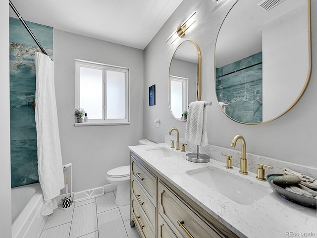 full bathroom with vanity, shower / bath combo with shower curtain, toilet, and tile patterned floors