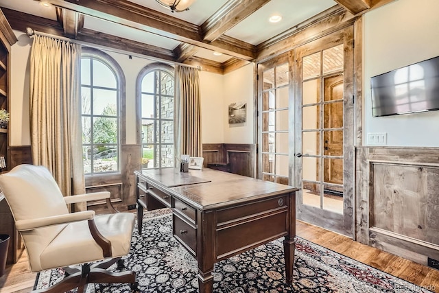 home office featuring a healthy amount of sunlight, a wainscoted wall, ornamental molding, and coffered ceiling
