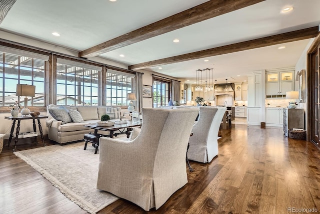 living room featuring dark wood-style flooring, beam ceiling, and recessed lighting