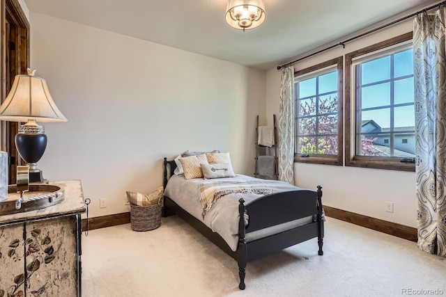bedroom with carpet floors and baseboards