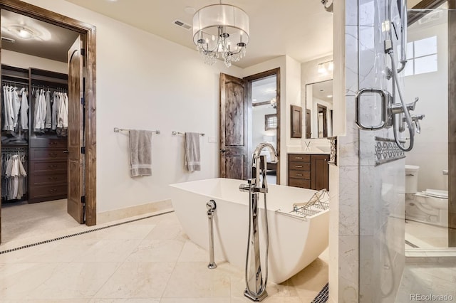 full bathroom featuring vanity, a soaking tub, baseboards, toilet, and visible vents