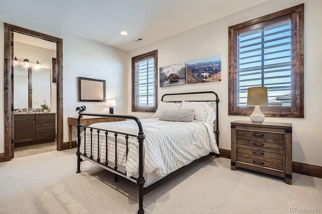 bedroom featuring light colored carpet, baseboards, connected bathroom, and visible vents