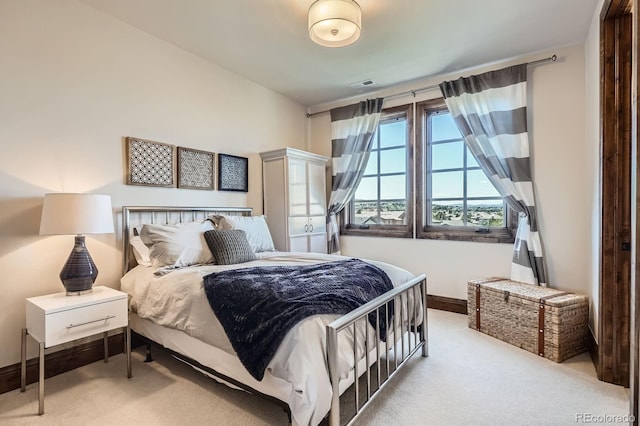 bedroom featuring carpet floors, visible vents, and baseboards