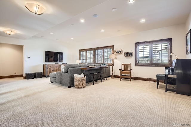 living room with recessed lighting, baseboards, and light colored carpet