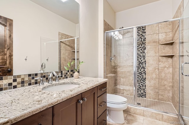 full bathroom featuring a shower stall, toilet, vanity, and tile patterned floors