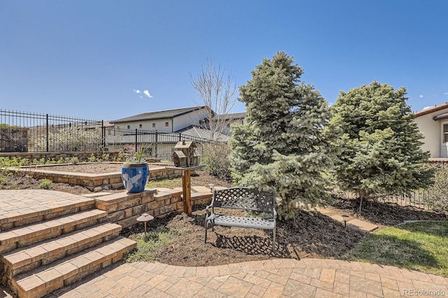 view of yard featuring fence and a garden