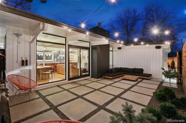 patio at twilight featuring fence