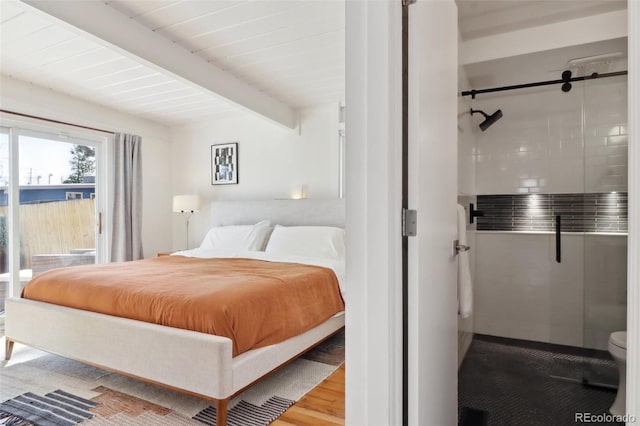 bedroom featuring access to exterior, beamed ceiling, and wood finished floors