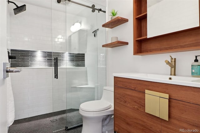 full bathroom featuring vanity, toilet, and a shower stall