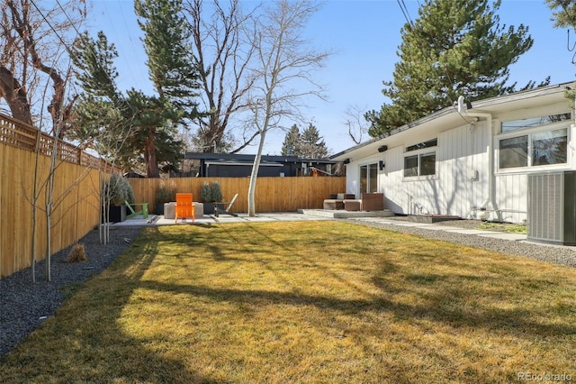 view of yard featuring a patio area, central air condition unit, entry steps, and a fenced backyard